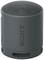 Compact, cylindrical Sony speaker in dark grey with a textured surface and a prominent Sony logo.