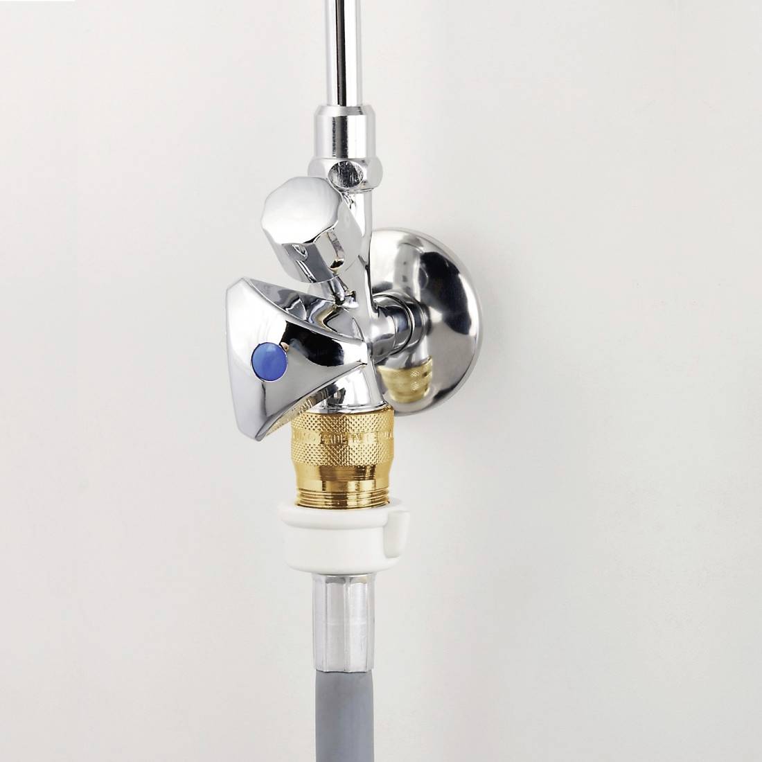 A chrome-plated valve for water pressure regulation, mounted on a wall. The valve has a brass connection and a blue dot.