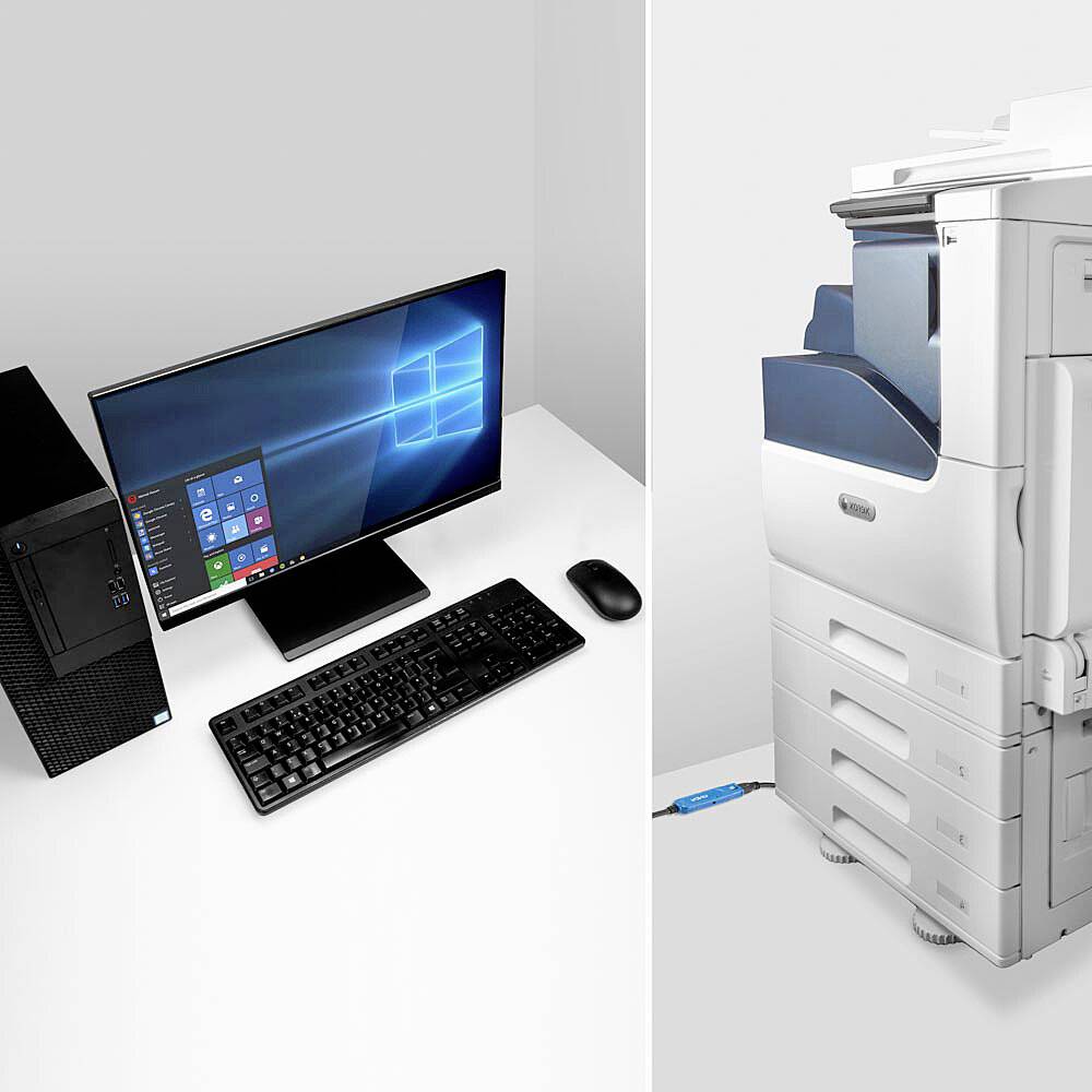 An office desk with a desktop computer, keyboard, mouse and a large printer ready for use.