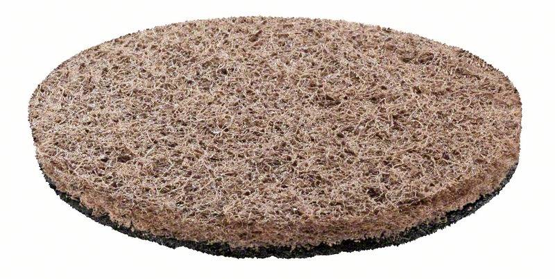 'Image shows a round, rough floor disc, likely a scouring pad, composed of coarse, brown fibres. Used for floor cleaning or abrasive work.'