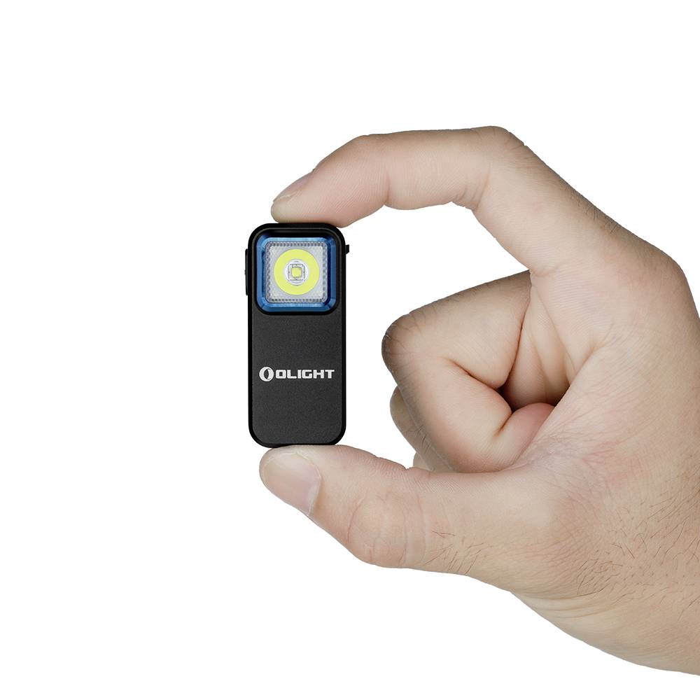A hand is holding a small, rectangular torch with the 'OLIGHT' inscription on the front.