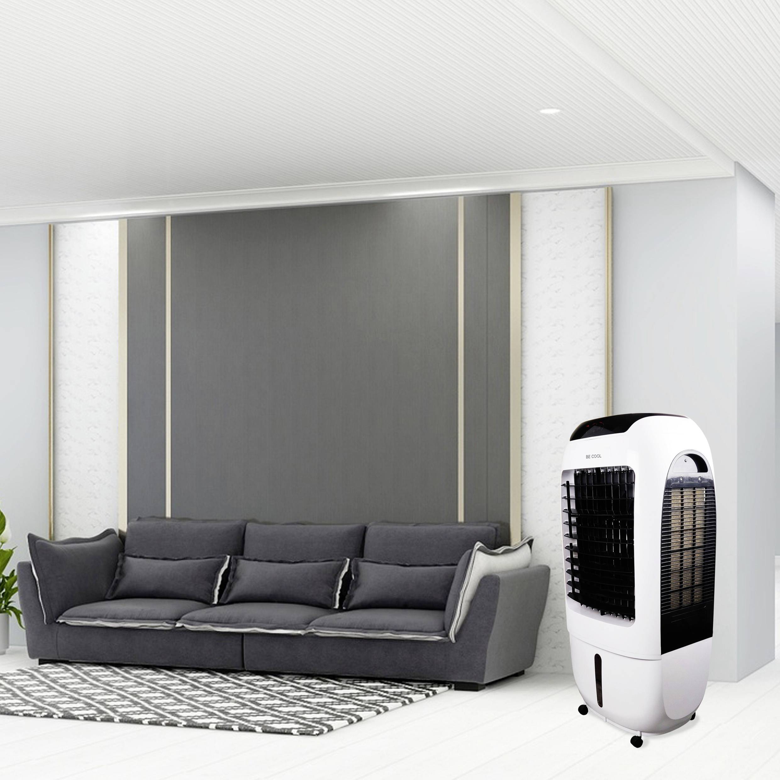 Grey sofa in front of a textured wall, next to a white air cooler on a light floor. Modern living room design.
