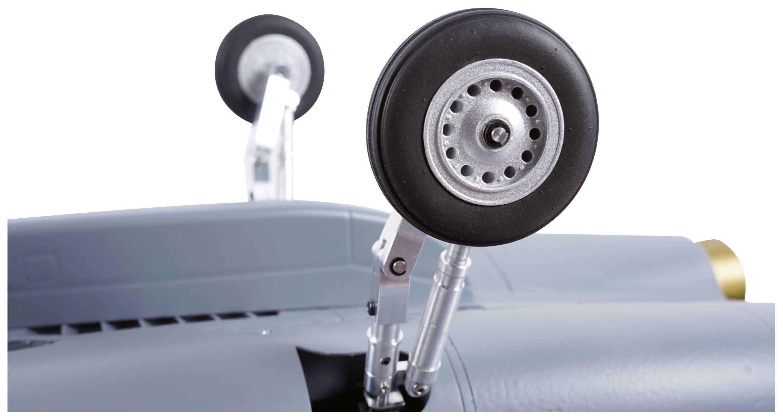 Landing gear of an aircraft model being extended. View of the wheels and mechanism emerging from beneath the aircraft fuselage.