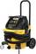 A yellow and black industrial vacuum cleaner with hoses and wheels. Suitable for construction sites or workshops for sucking up dirt.