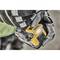 A person is wearing work gloves and holding a yellow, battery-powered tool, possibly a drill, in their hand.