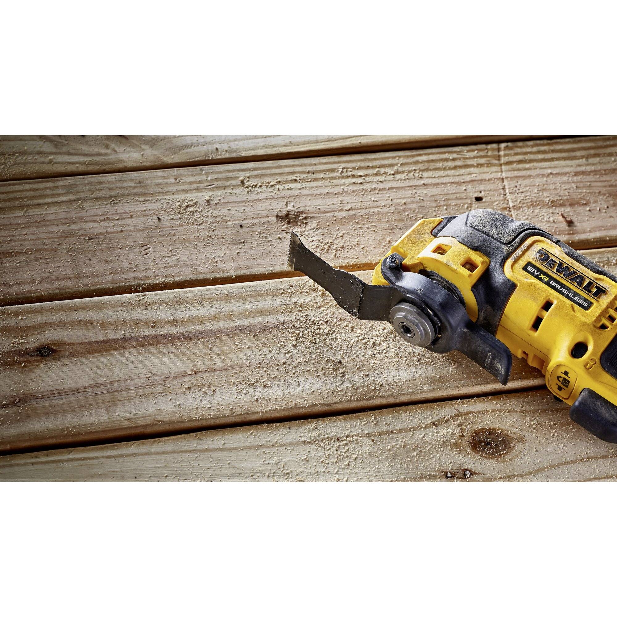 Electric power tool on a wooden table, ready to cut wood. The tool has a yellow casing and a blade for processing.