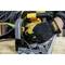 A person is wearing work gloves and operating a circular hand saw on a wooden board, focusing intently on the cut.