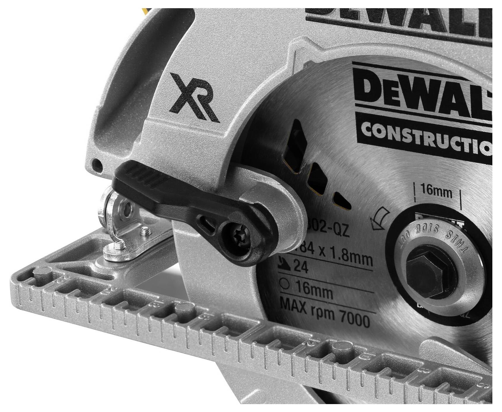 Close-up of a circular saw with a silver saw blade and black handle. Technical details are printed on the saw.