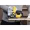 A person is using a yellow circular saw to cut a wooden board. The focus is on the saw and the wood being cut.