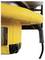 Yellow electrical power tool corner with power cable connection, likely part of a larger device, with signage panel on the side.