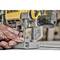 A person is holding a yellow power tool and adjusting its settings. The scene appears to be in a workshop.
