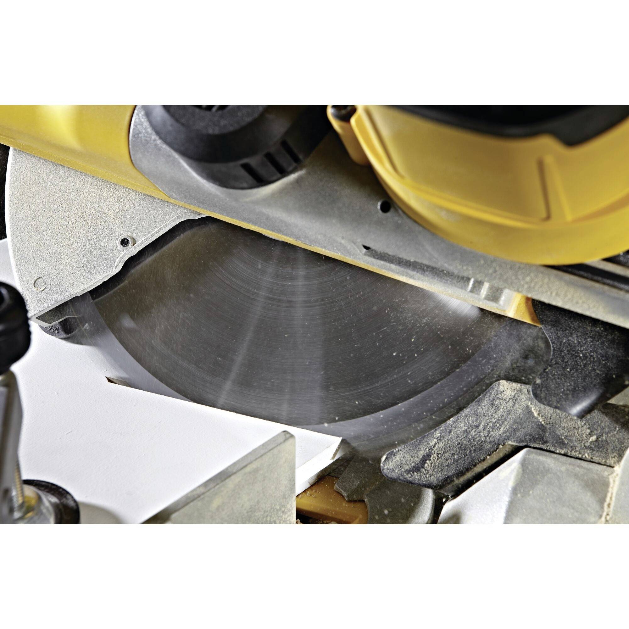 Close-up of a circular saw running in a woodworking workshop. The saw is in operation and is currently cutting a piece of wood.