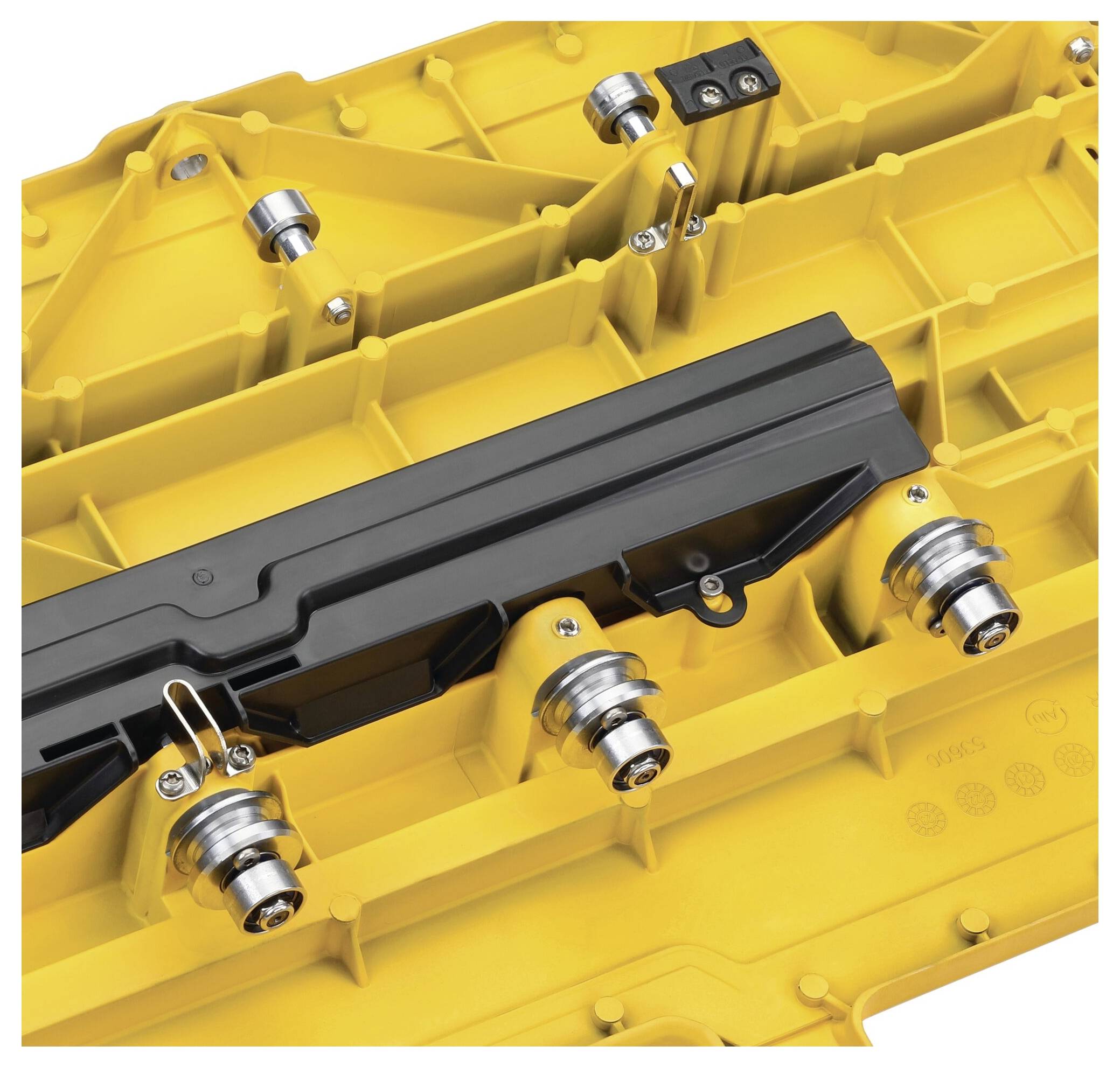 Yellow component with a complex structure and multiple silver connections, potentially part of a larger technical machine.