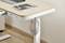 Wooden desk with a laptop and a magazine titled 'DESIGN' on its surface. Headphones are hanging on the side.