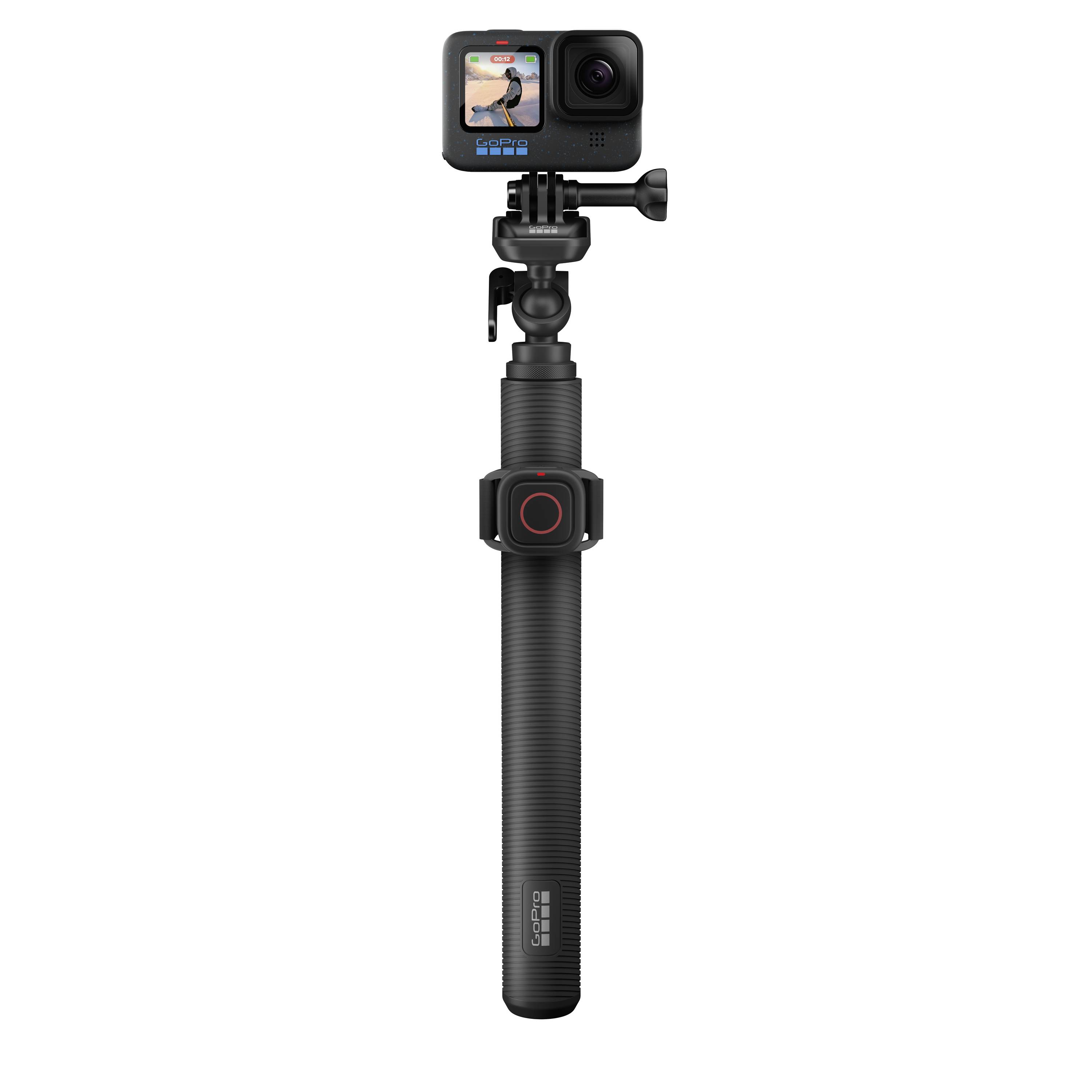 Action camera on a black selfie stick, display showing an image.