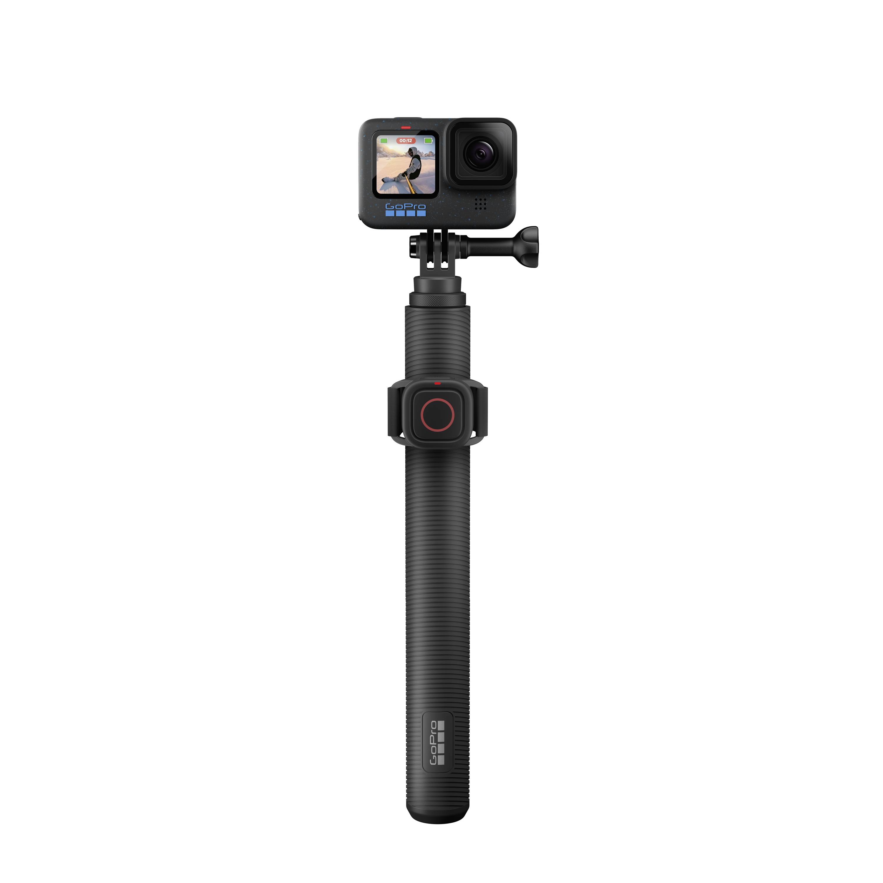 An action camera mounted on a long, black handheld tripod.