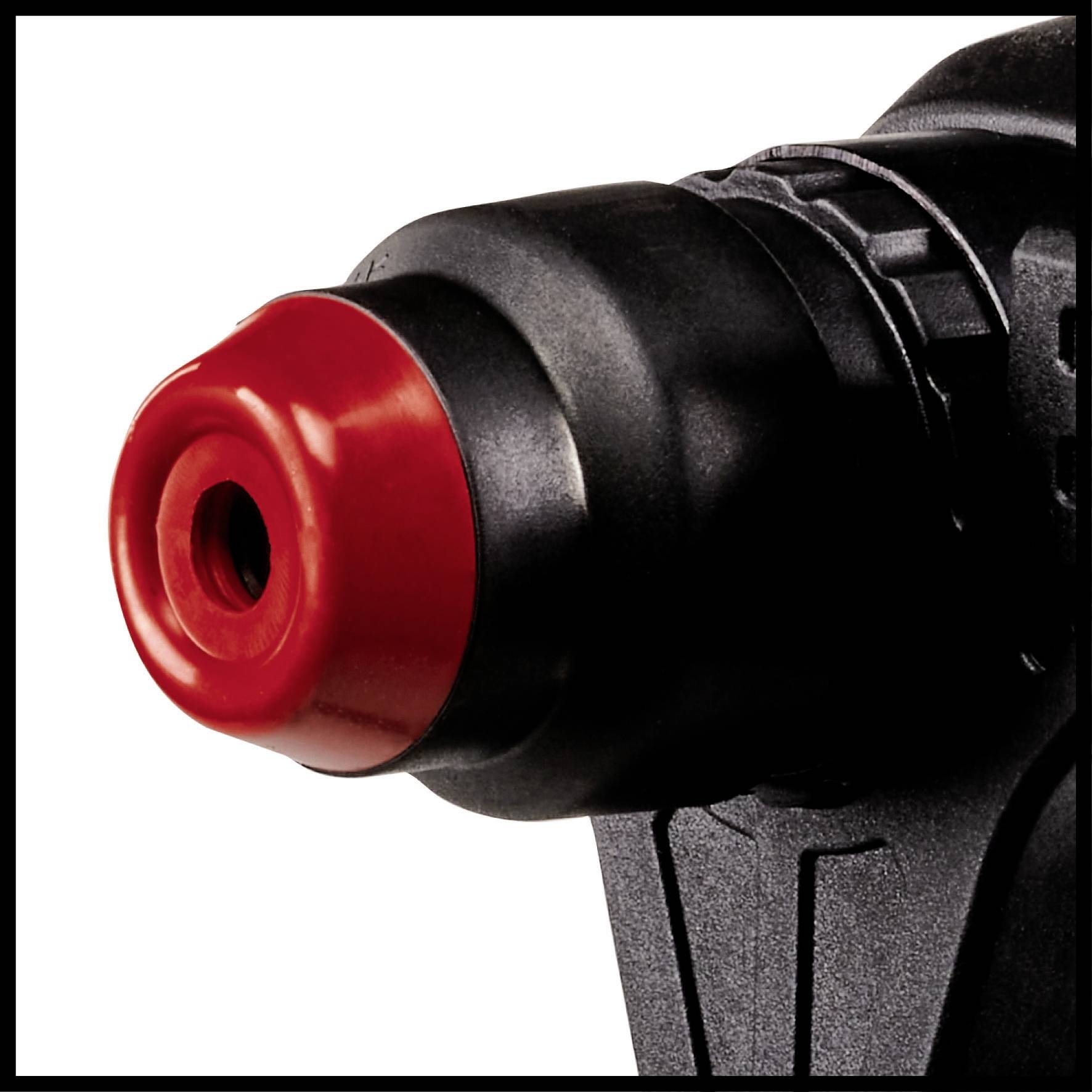 Close-up of a red and black cordless drill with focus on the chuck.