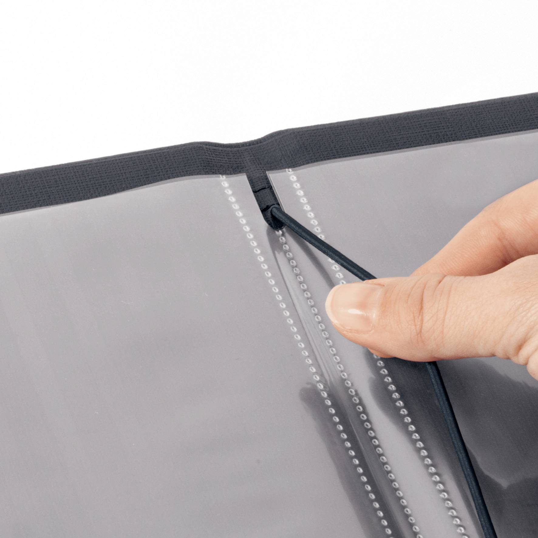 A hand opens a black zip on a transparent plastic folder.