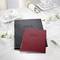 White table decoration with flowers, glasses, and menu cards in black and red with the inscription 'Food & Drinks'.