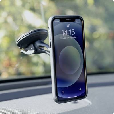 A smartphone with a black case is mounted in a car holder on the windscreen. The screen displays 14:15.