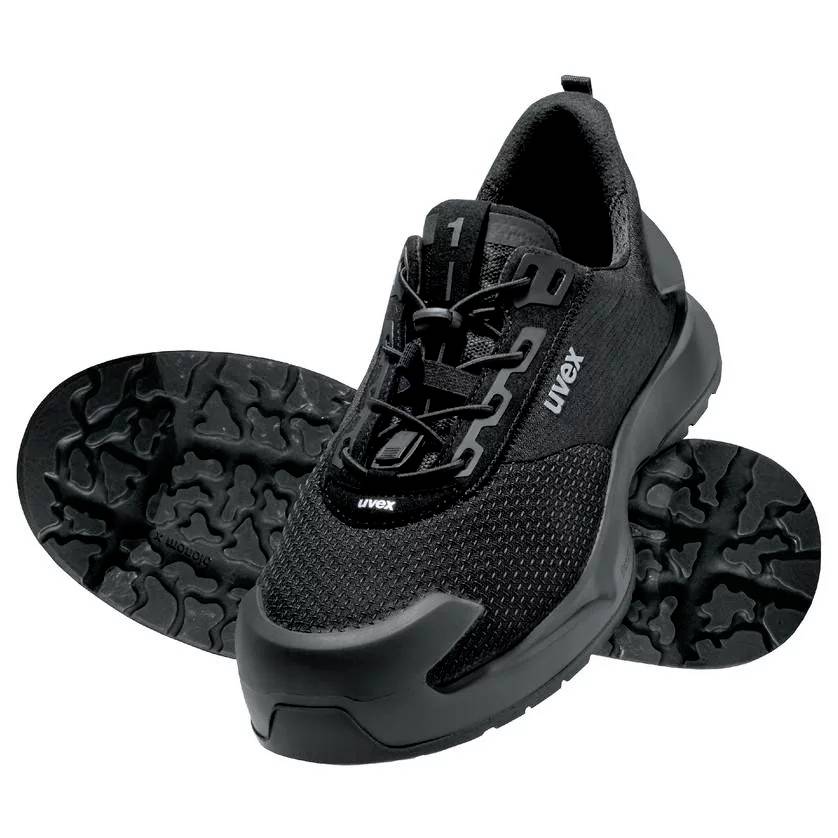 Black safety shoe with non-slip sole and robust toe cap, suitable for industrial use.