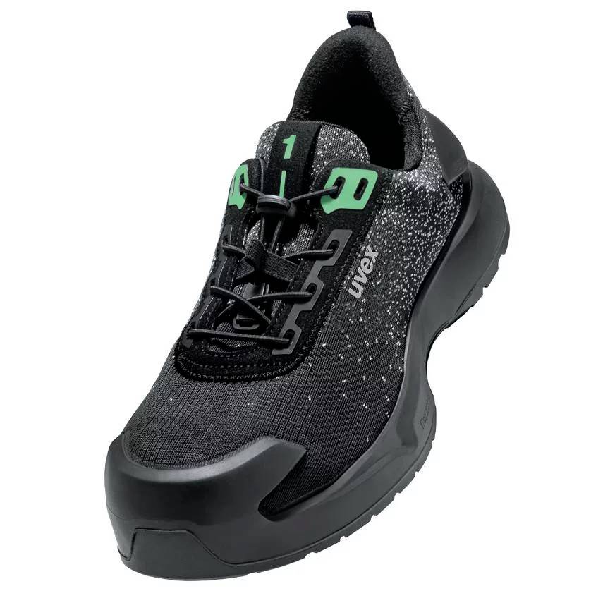 Black work shoe with green accents, reinforced protective toe cap and sturdy sole. 'uvex' marking visible on the side.