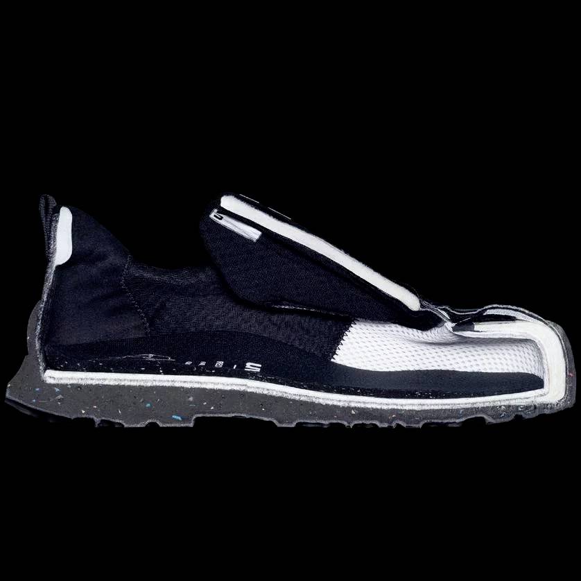 A training shoe from the side, showing its construction and materials, with a black and white colour scheme and a sporty design.