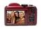 Back of a red digital camera shows a display with an image of four smiling people.
