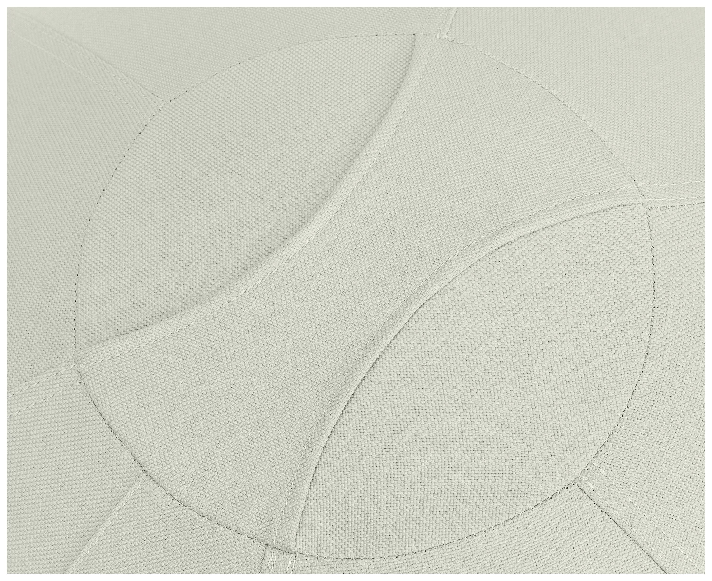 The close-up reveals a grey fabric texture with circular, overlapping patterns that form an aesthetic texture.