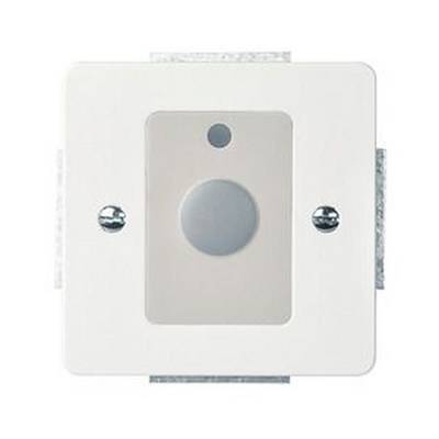 A white wall switch with a large central button and a small hole above it, mounted in a rectangular frame.