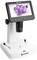 Digital microscope with screen shows an image of purple crystals. Device has control buttons and a white base.