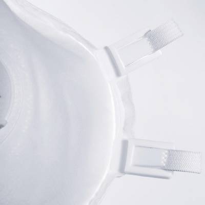 White protective face mask with elastic straps, partially visible in the image, against a light background.