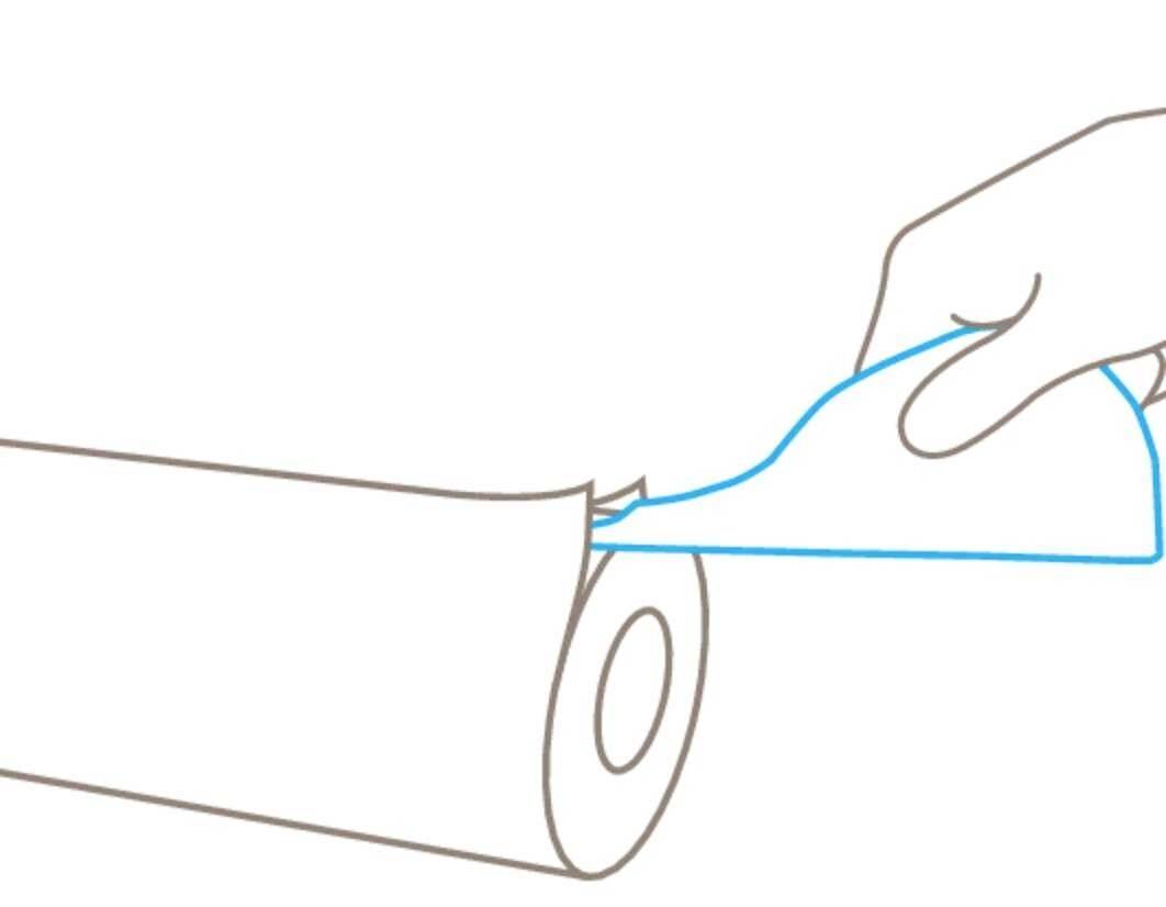 A hand tears a single sheet from a roll of kitchen roll.