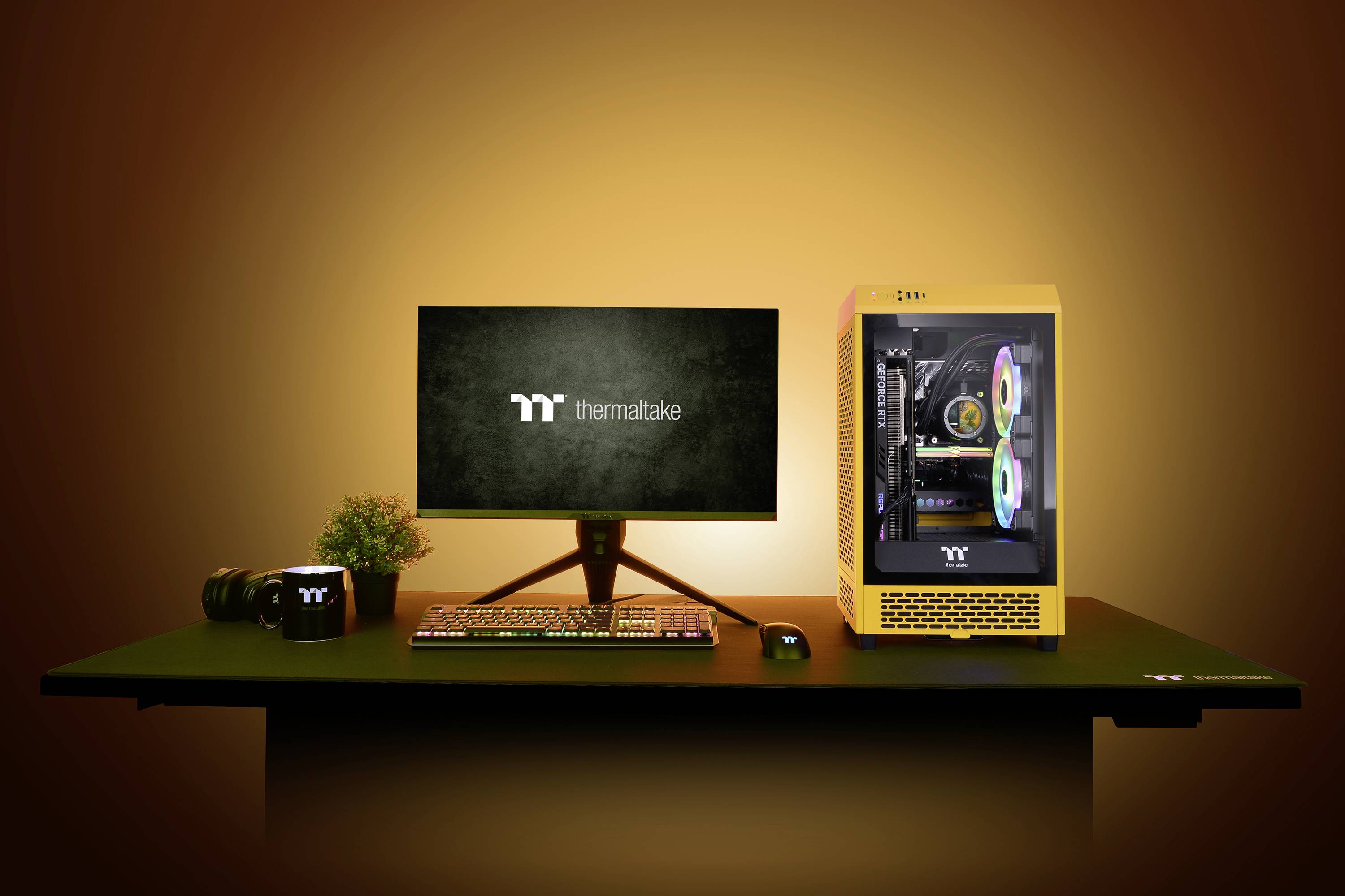 Desk with a computer-controlled monitor, yellow PC tower with illuminated fans and keyboard, decoratively lit.