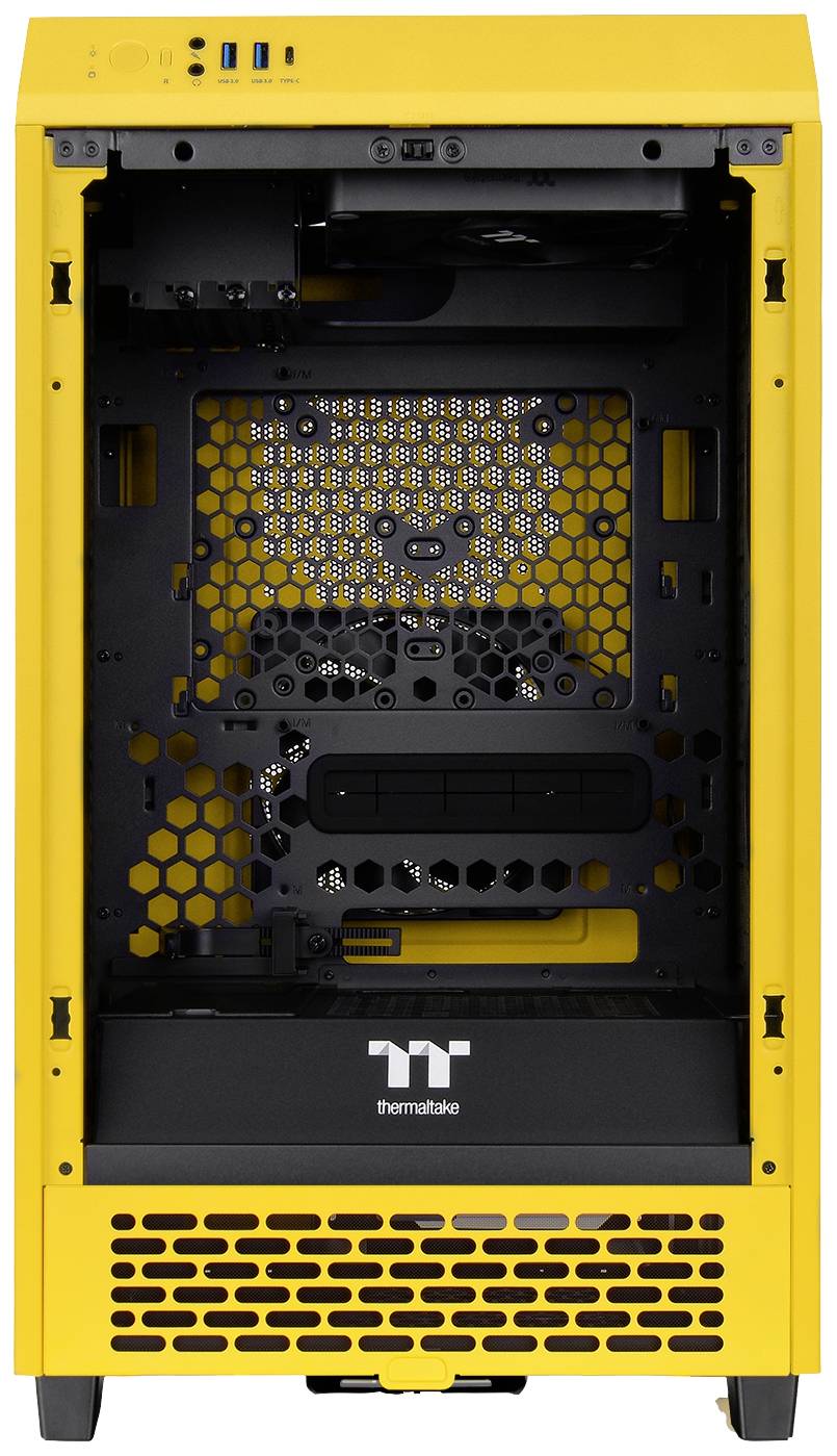 Yellow computer case, front view without side panels. Visible ventilation grilles and mounting brackets for internal components. Brand logo at the bottom.