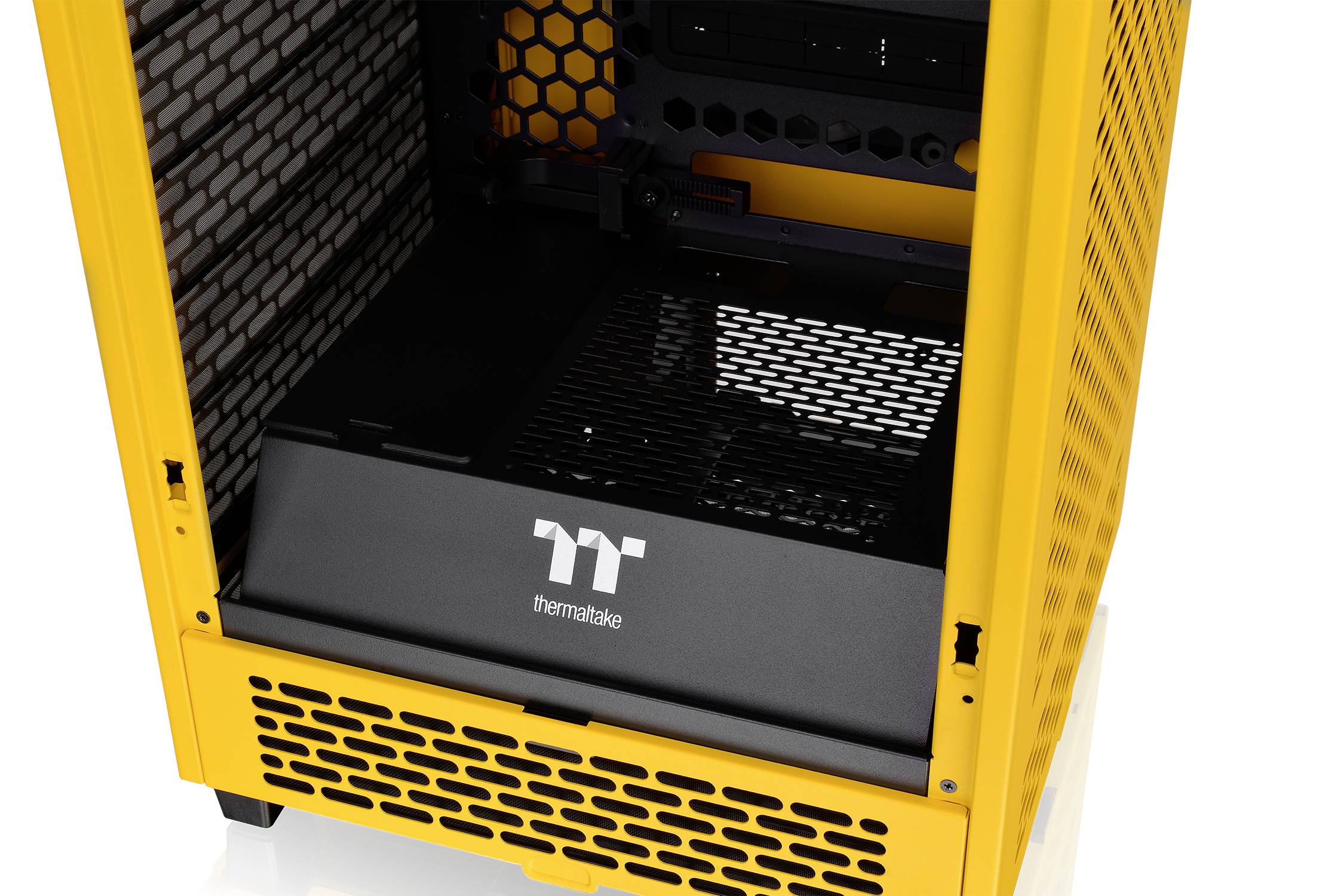 Yellow computer case with an open side panel, revealing the interior with ventilation grilles and space for hardware components.