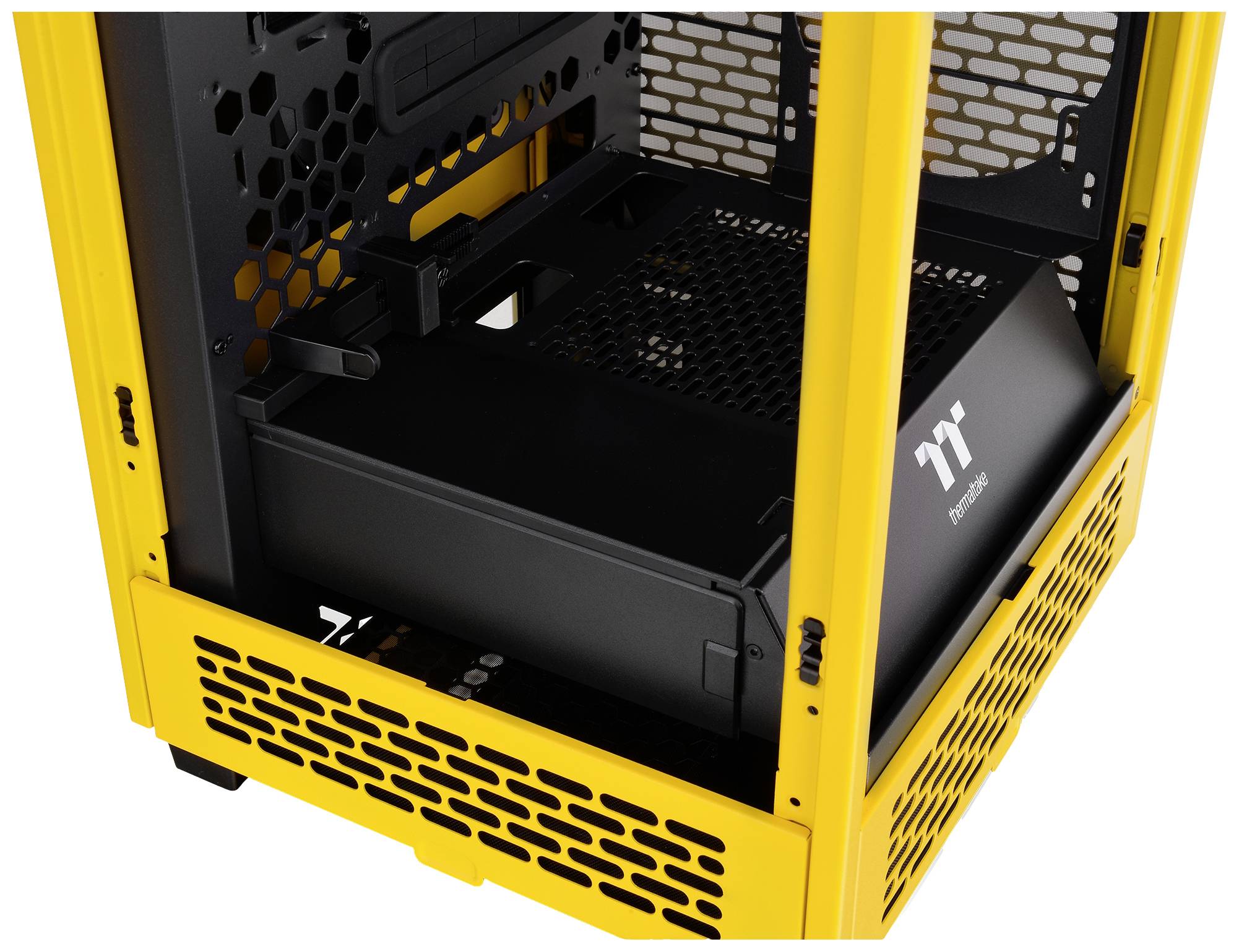 A yellow computer case with a transparent side window, revealing its spacious interior and multiple ventilation slots on the front panel.