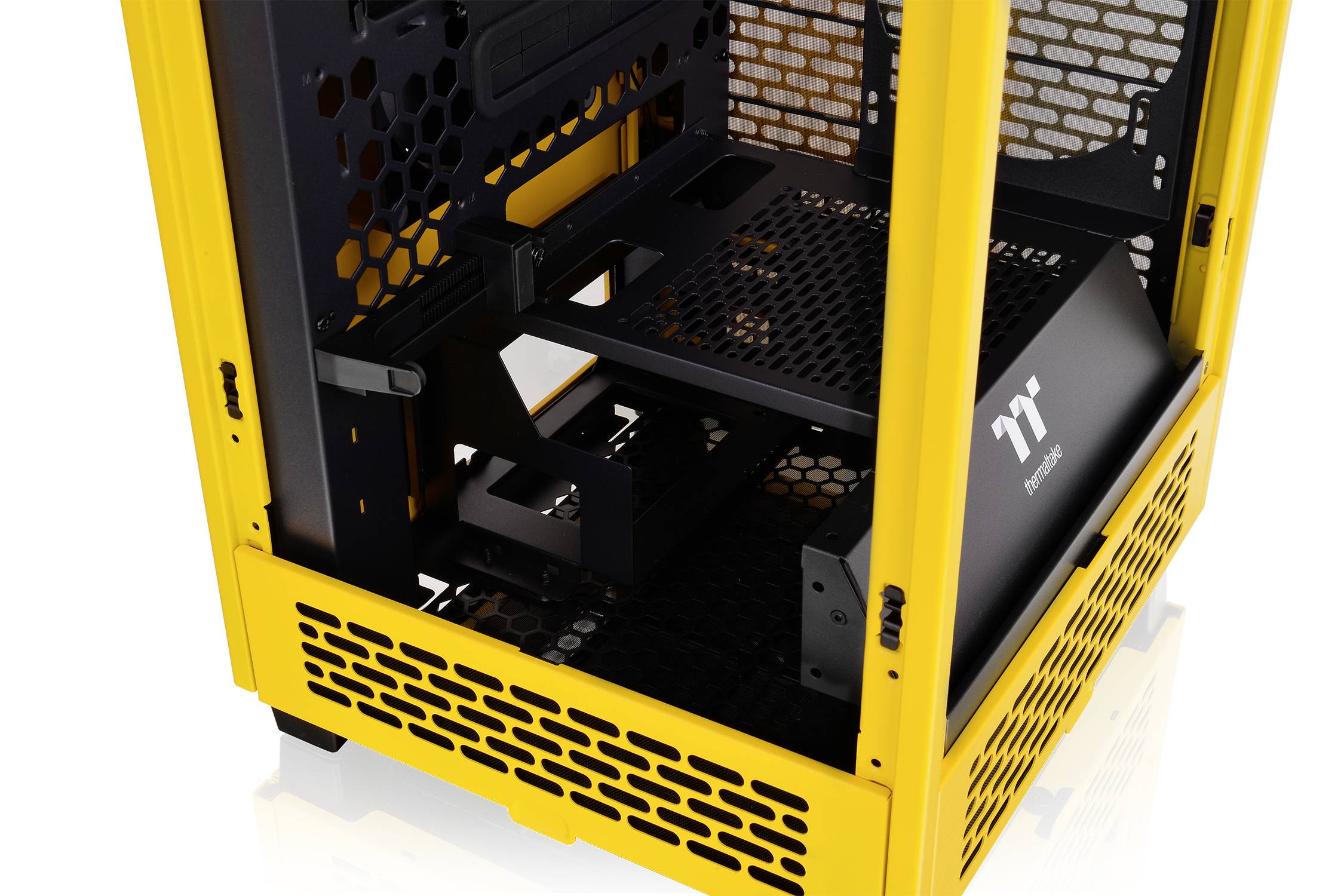 Gaming PC case with a yellow frame and black interior, open structure with ventilation grille for enhanced cooling.