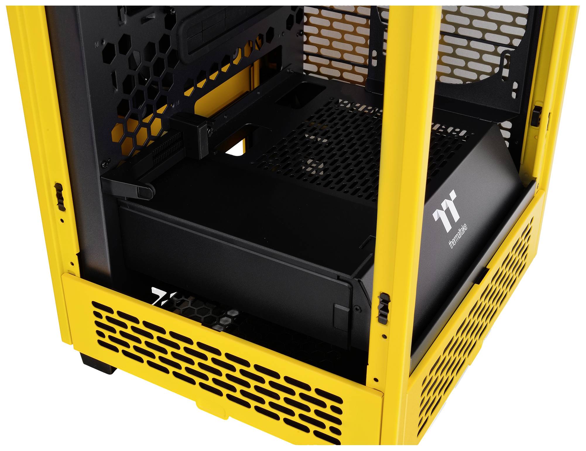 Yellow computer case with a black interior, mesh structure for ventilation. Side partially open, brand logo visible.