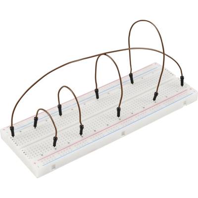 A breadboard with several bent wires connecting different socket positions.