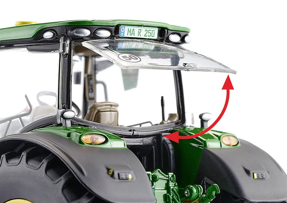 A green tractor with a flipped-up window on the windscreen. A red arrow points to the movable part.