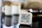 Digital thermo-hygrometer displays 26.0°C and 39% humidity, with blurred cups in the background.