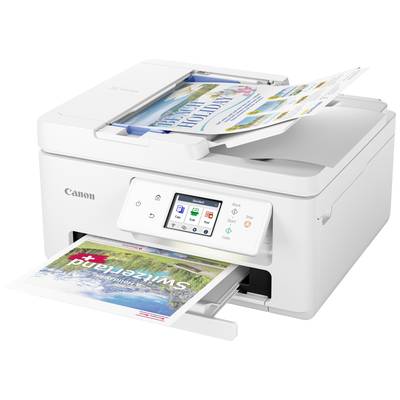 A white Canon printer is printing a photograph. Two brochures are sitting in the output tray. A screen displays printing options.