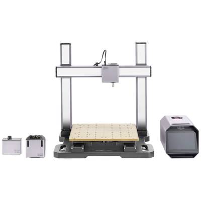 A 3D printer with a rectangular frame, wooden bed in the centre, accompanied by two small square modules and a larger device on the right.