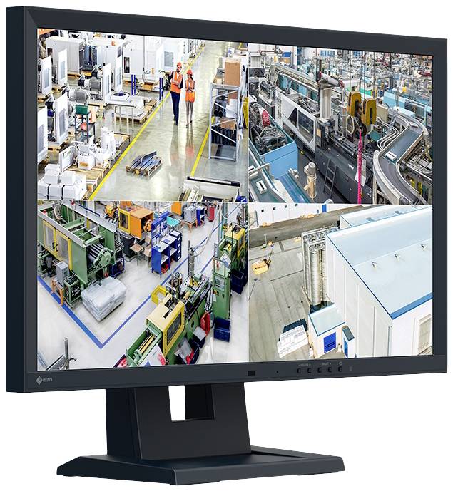 Image of a monitor displaying four live feeds of a factory hall: workers, machines, production lines, and storage areas.