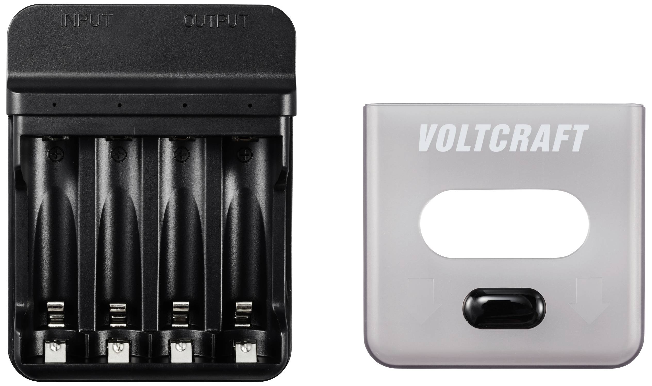 Battery charger with four empty battery compartments and a removable transparent cover, labelled 'Voltcraft'.