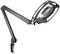 Black desk magnifying lamp with adjustable arm and built-in illumination element, mounted on a desk edge.