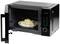 An open microwave displays a plate with a rice dish inside. The digital display shows '2:39'. Buttons for various functions are visible.