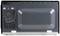 Rear view of a microwave, shown with ventilation grille and power cable on the left-hand side. Device is positioned on a flat surface.