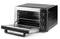 A black toaster oven with its door open, revealing shelves and side controls for temperature setting and timer.
